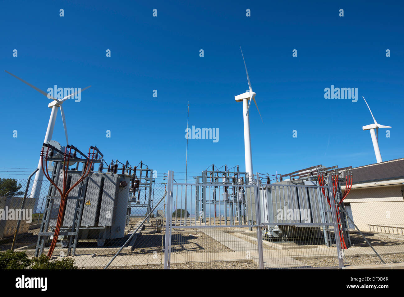 windmills for removable energy production and electrical substation, El Buste, Zaragoza, Aragon, Spain Stock Photo