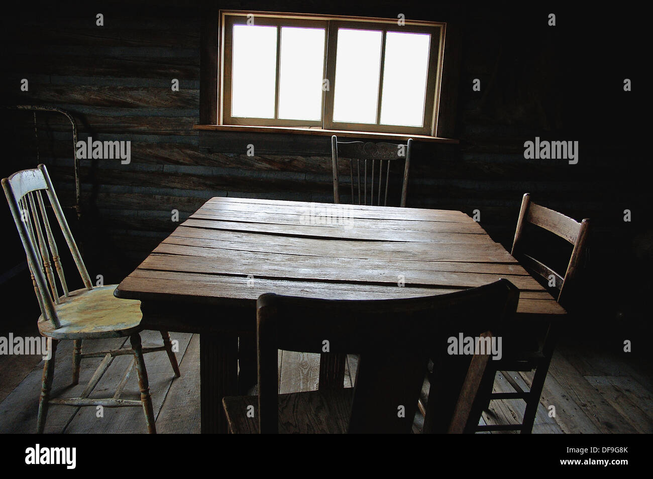 Old Empty Wooden Table With Four Chairs Seems To Wait For A