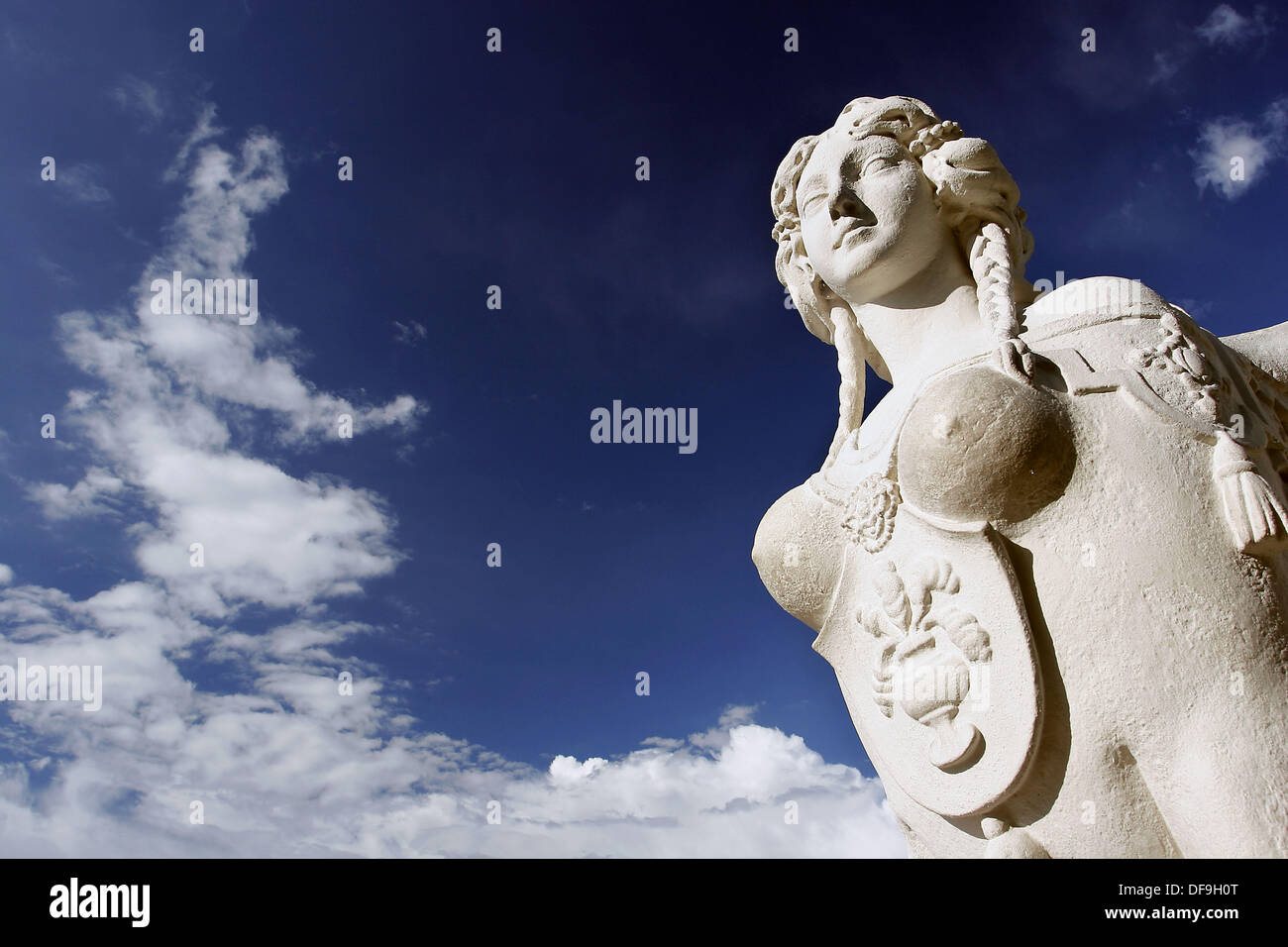 A sphinx statue with lion body and human heads adorning the gardens in