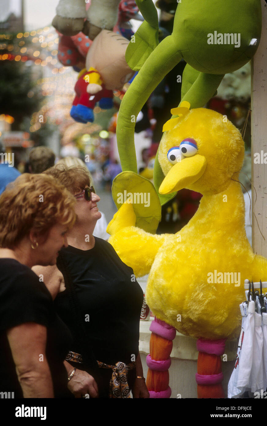 Two older women (sisters?) admiring a big bird stuffed toy at the San Gennaro Street Festival in Little Italy, NY. USA Stock Photo