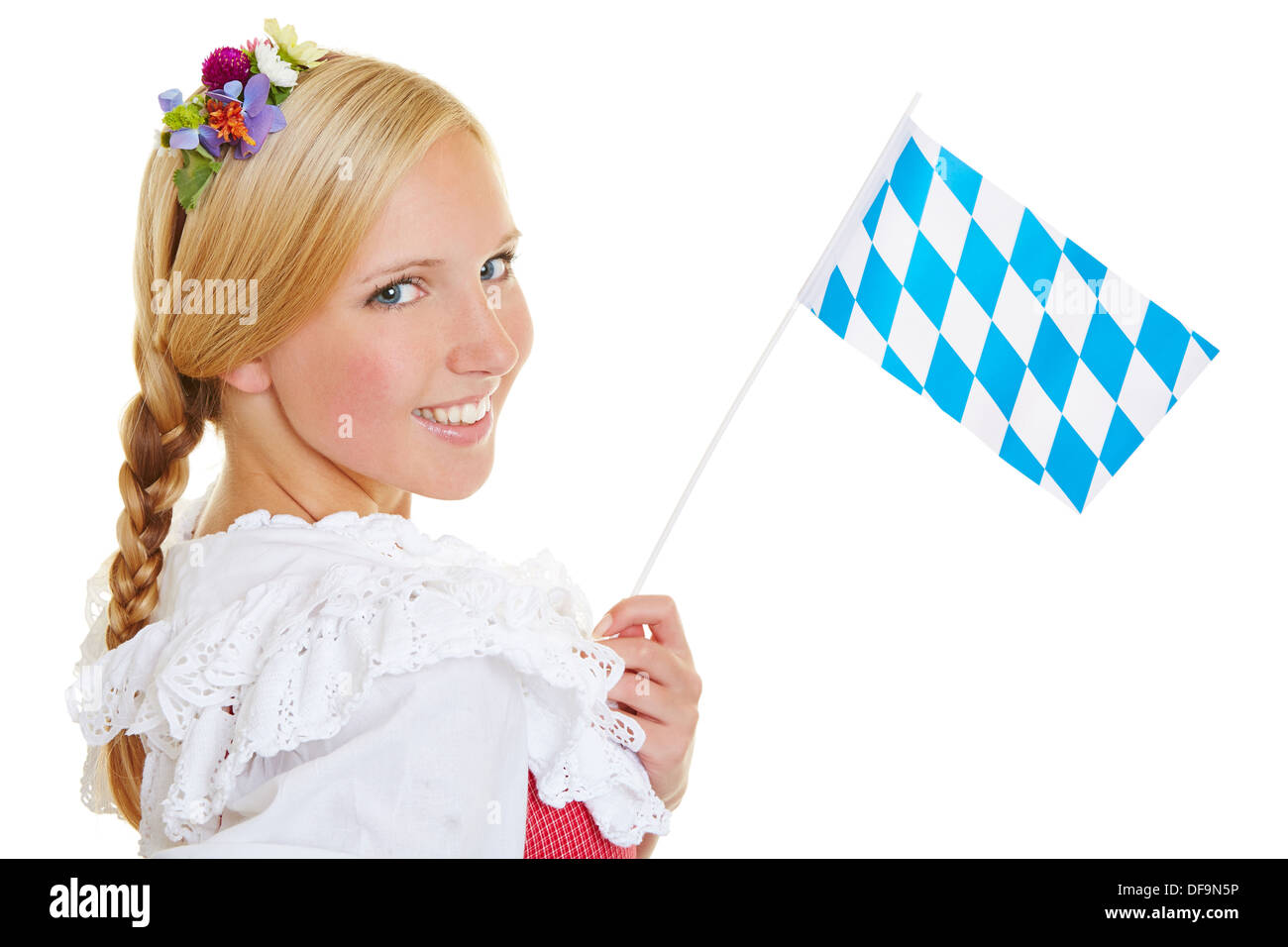 Young happy woman smiling with a bavarian flag and dirndl Stock Photo