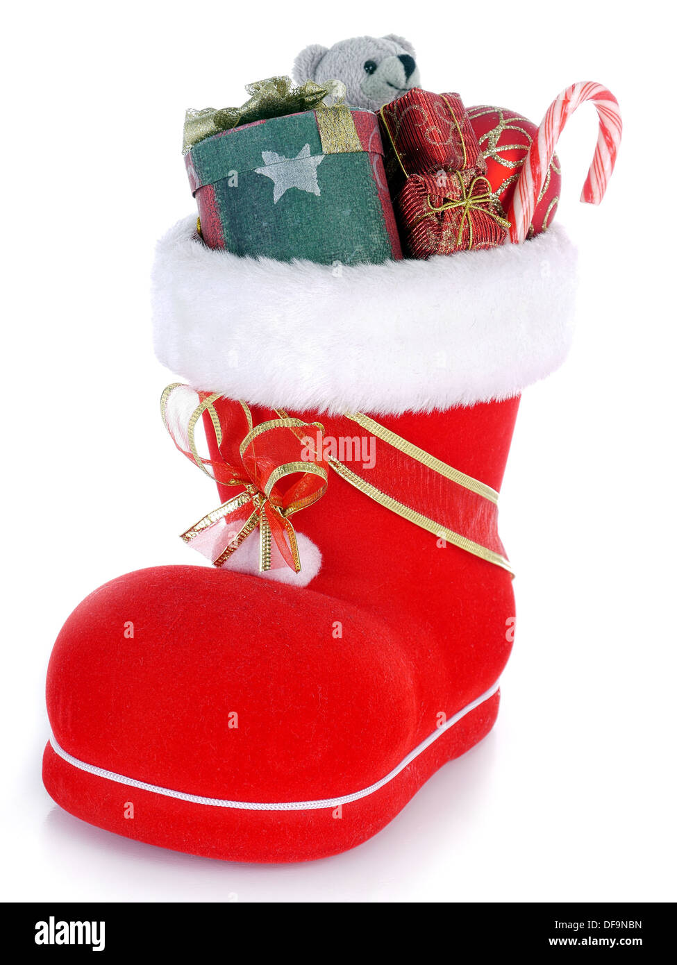 Red Santa's shoe stuffed with Christmas presents over white background Stock Photo