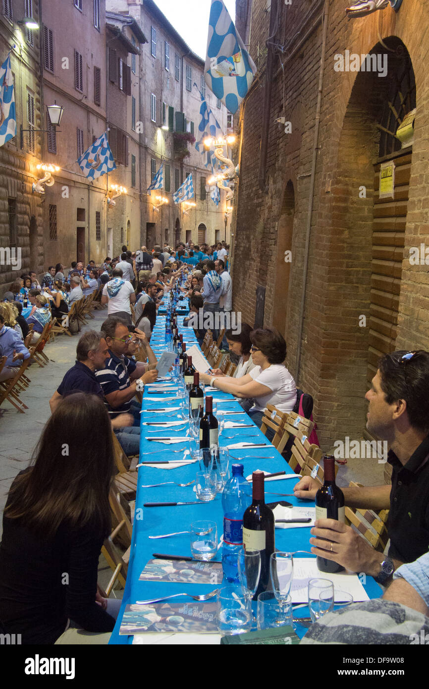 'Onda' (Wave) contrada (district) meal after the general Palio trial, the evening before the Palio itself, Siena, Tuscany, Italy Stock Photo