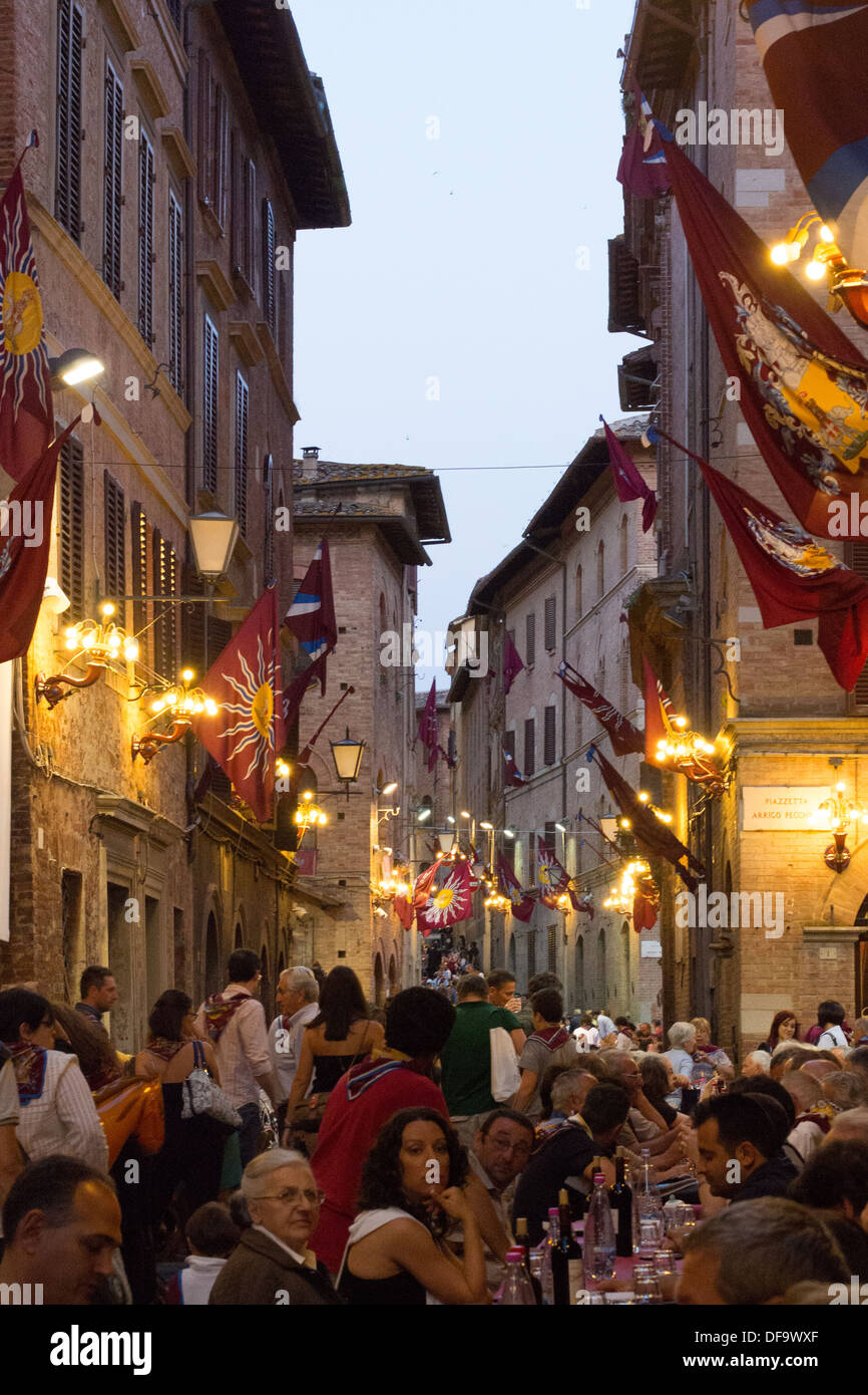 'Torre' (Tower) contrada (district) meal after the general Palio trial, the evening before the Palio, Siena, Tuscany, Italy. Stock Photo