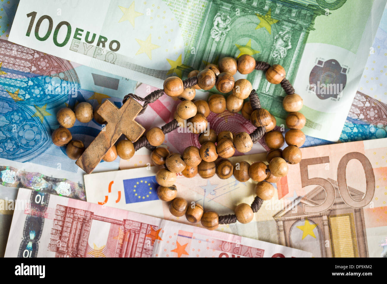 top view of rosary beads on euro bills Stock Photo