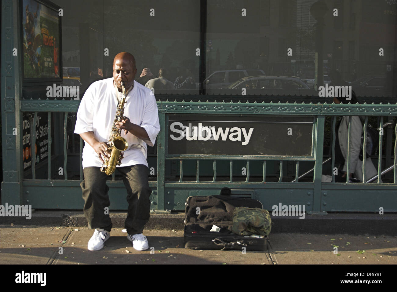 Man playing saxophone on street at Subway entrance. NYC. USA Stock