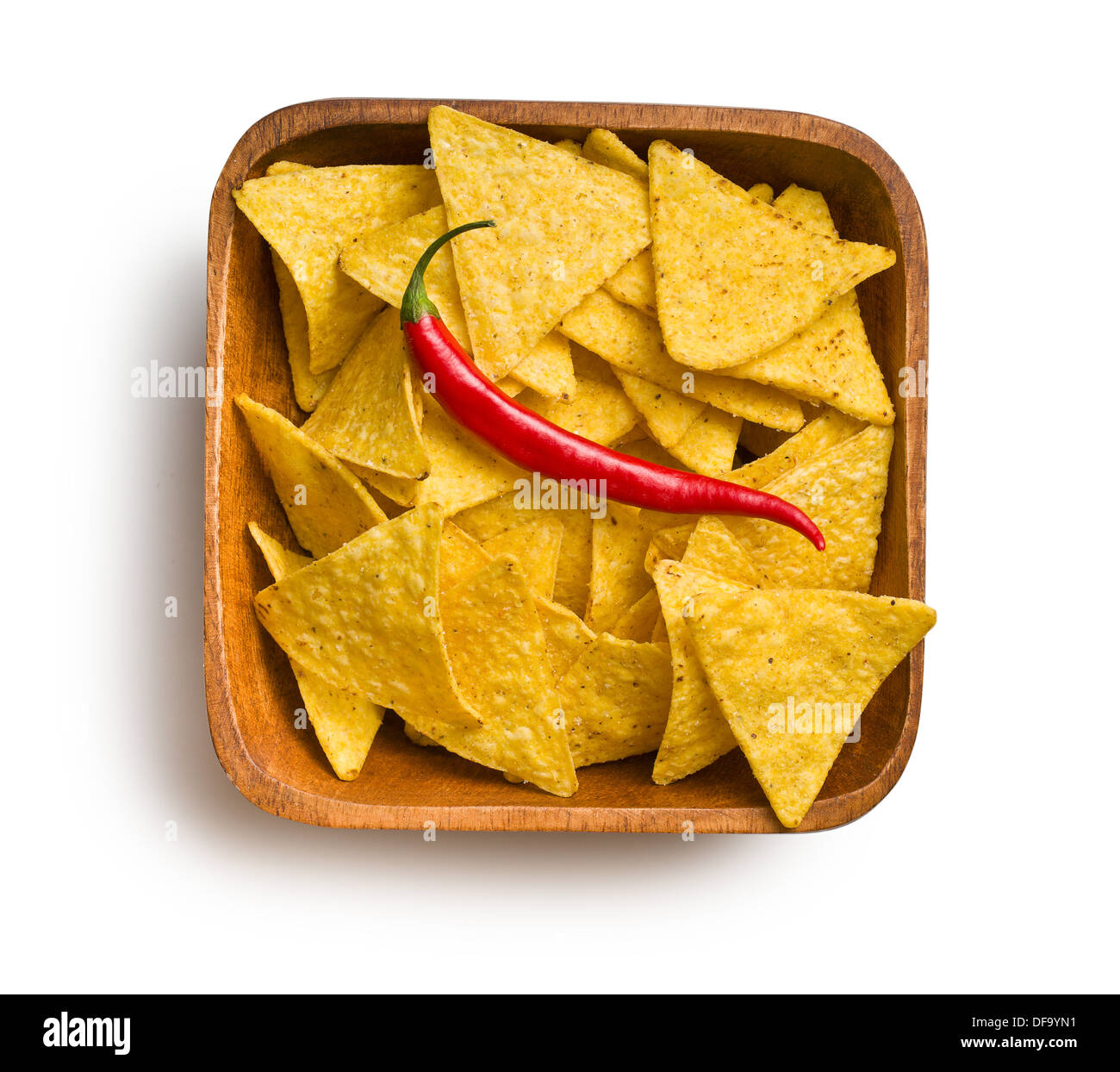 top view of tortilla chips with red chili pepper in wooden bowl on white background Stock Photo