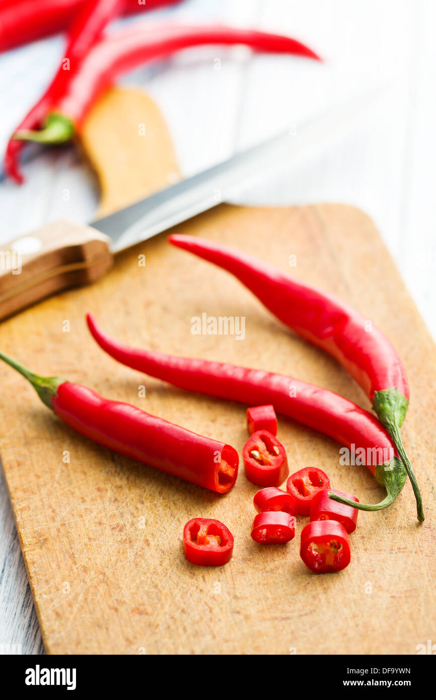 red chili peppers on cutting board Stock Photo