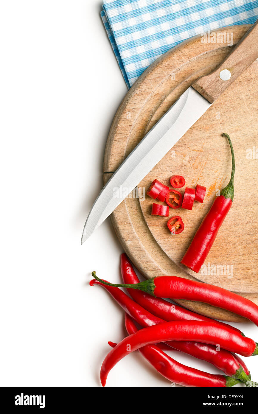 top view of chopped chili pepper on cutting board on white background ...