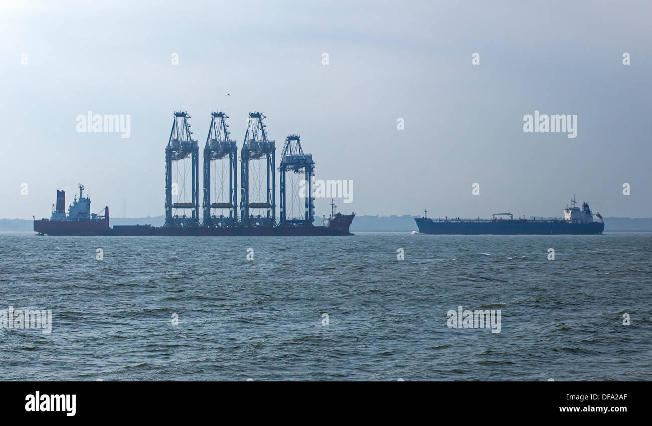 Zhen Hau 24 Delivering Cranes to New Deep Water Terminal at London Gateway Just About to Pass an Outbound Cargo Ship Stock Photo