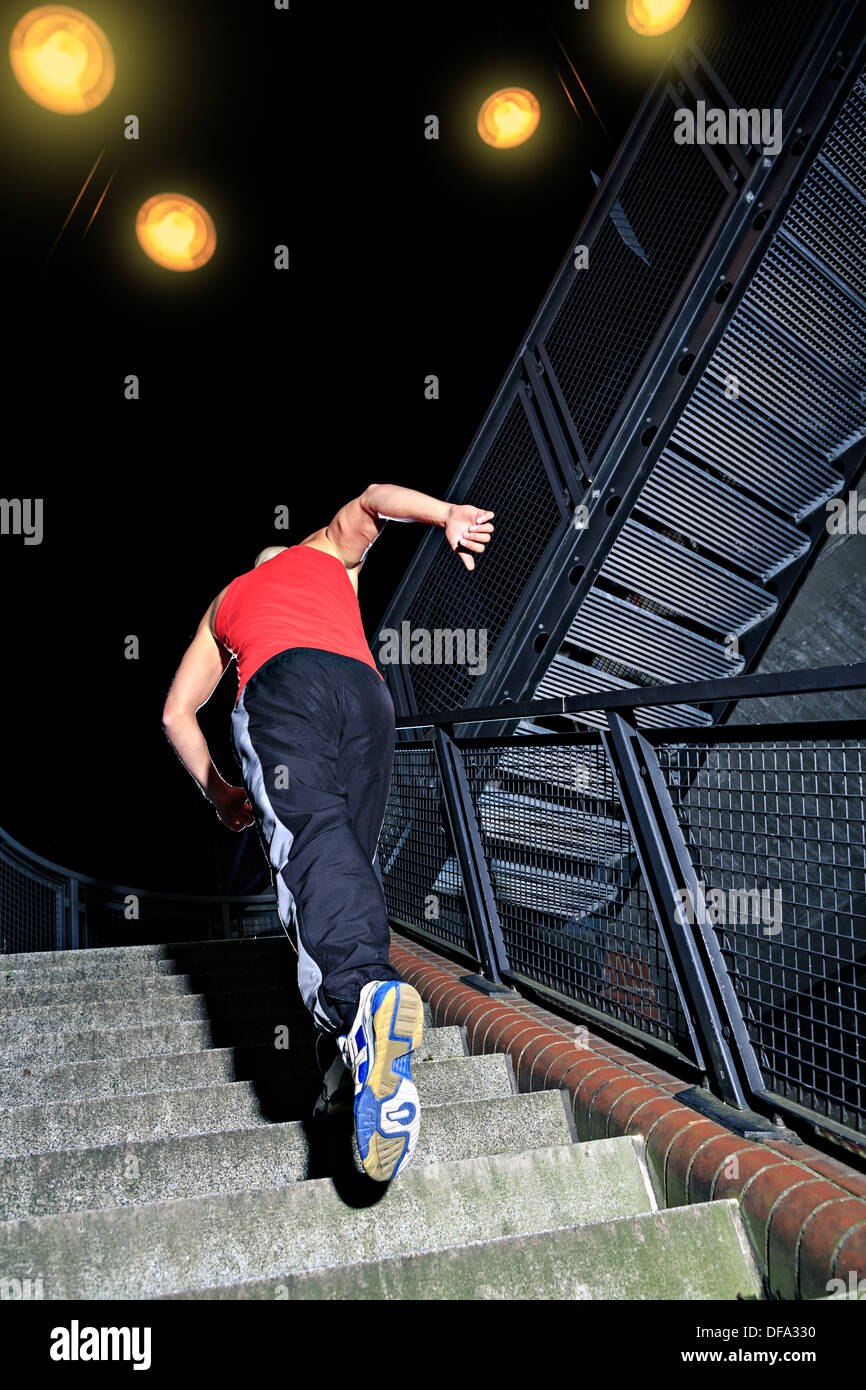 A young man at parkour training in the city Stock Photo