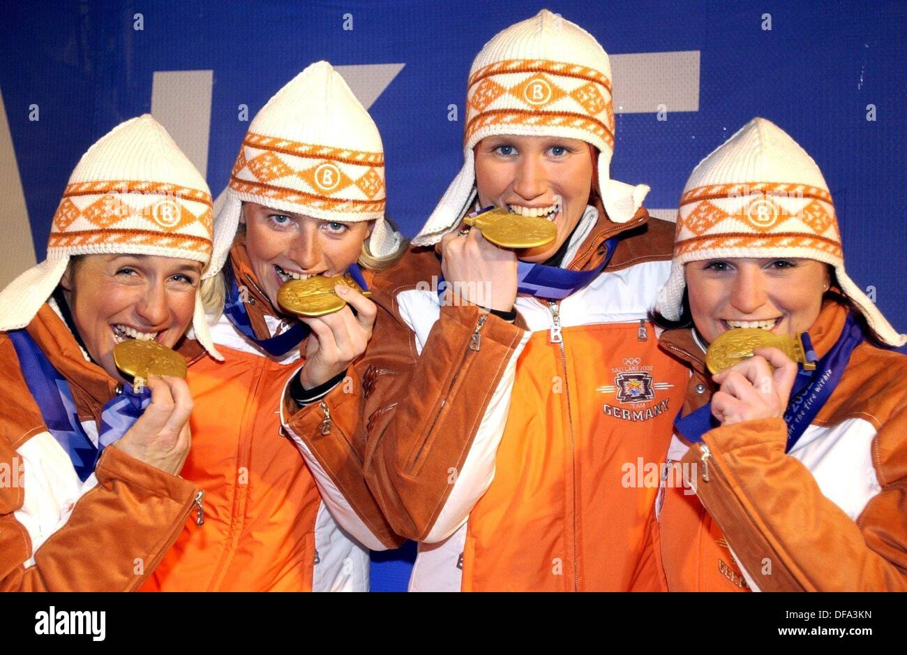 (dpa) - XIX Winter Olympic Games: The gold medal winners of the Biathlon - Relay Women (l-r) Uschi Disl, Karin Apel, Kati Wilhelm und Andrea Henkel are radiantly presenting their goldmedals at the presentation ceremony on 18.2.2002 at the Medal Plaza in Salt Lake City. They won their eighth gold medal for Germany, leaving Norway and Russia behind. Stock Photo