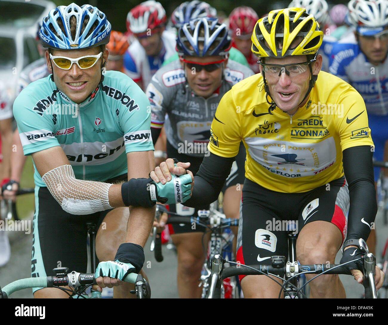 (dpa) - German Jan Ullrich (L) of Team Bianchi congratulates US Postal-Berry Floor's Lance Armstrong from the US, who wears the overall leader's yellow jersey, during the 20th stage of the 2003 Tour de France cycling race in Ville-d'Avray, France, 27 July 2003. In the backgournd Russia's Vjatceslav Ekimov. The race's final stage to Paris is traditionally a ceremonial ride in which no one challenges the overall lead. So barring disaster, Armstrong will match Miguel Indurain's record of five consecutive victories in cycling's most prestigious event. Ullrich is placed second in the general standi Stock Photo