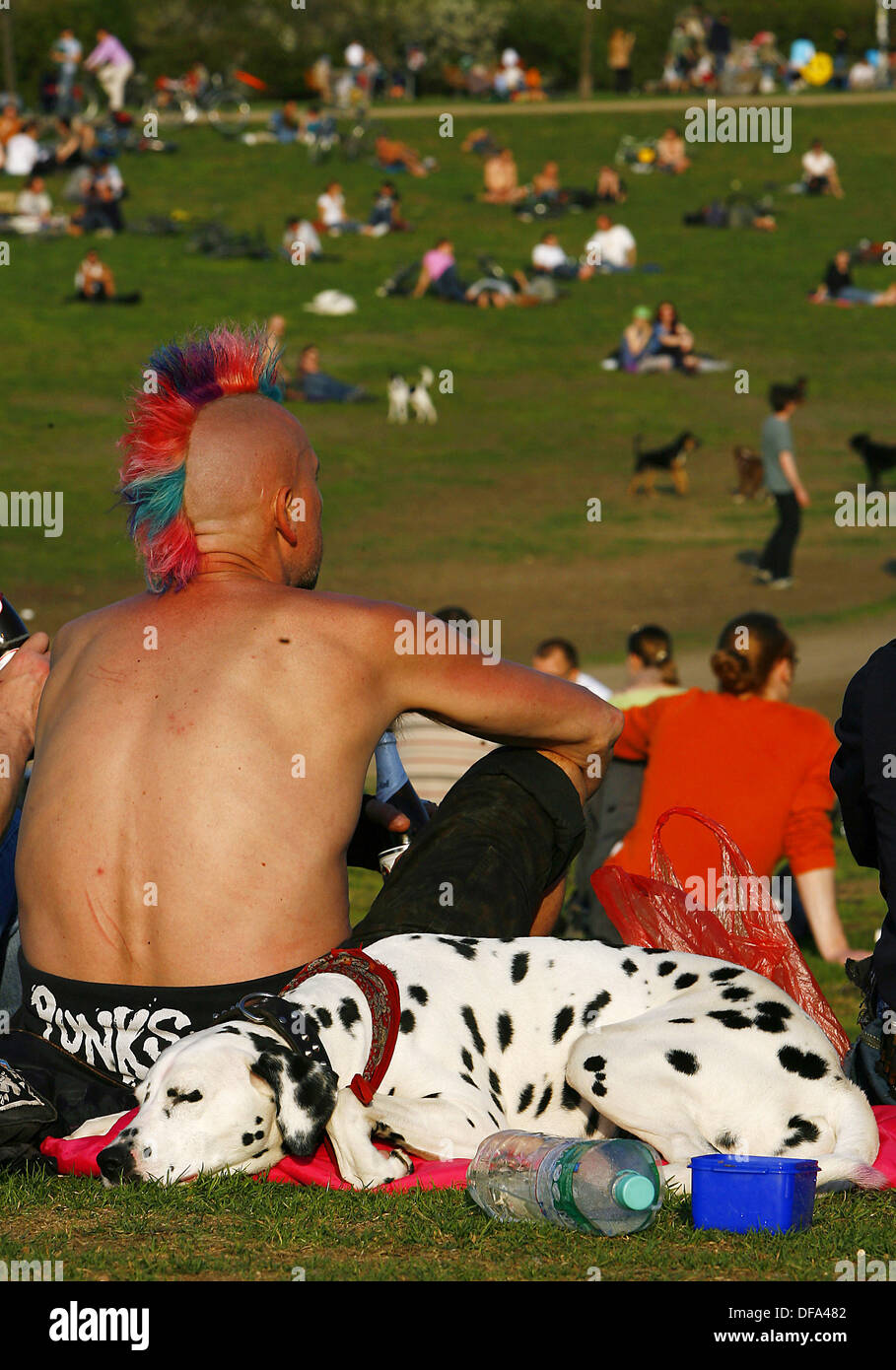 A punk and a Dalmatian dog enjoy the evening sun on the 26th of April in 2006 in Berlin. Stock Photo