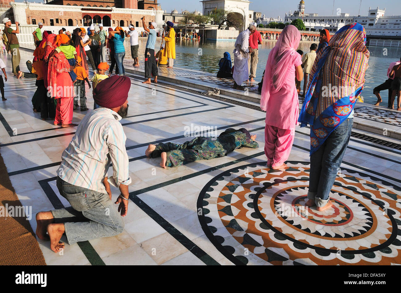 Sikh pilgrims praying for the God in Golden Temple Stock Photo