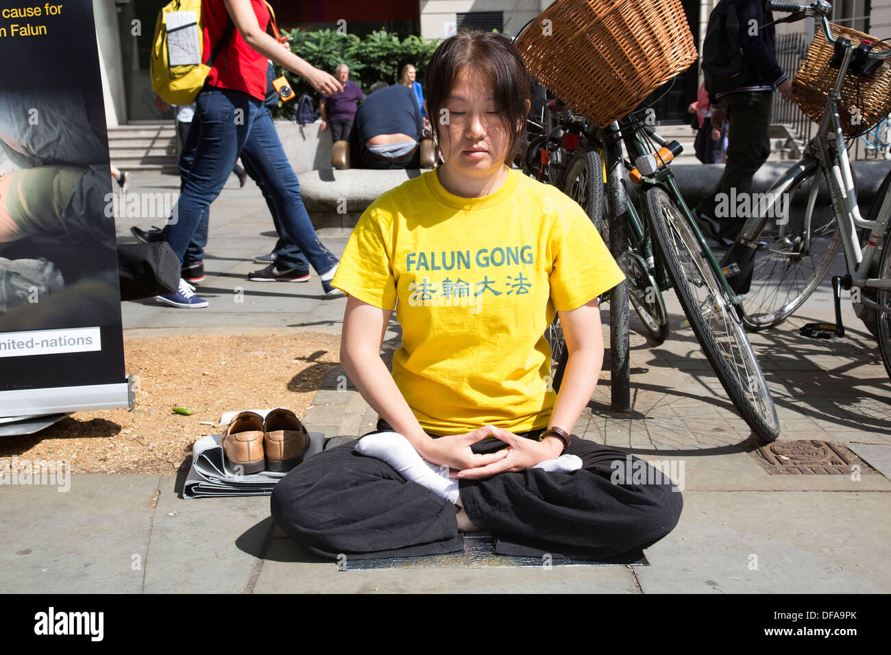 Members of Falun Gong or Falun Dafa sit in the lotus position meditating in protest in central London, UK. Stock Photo