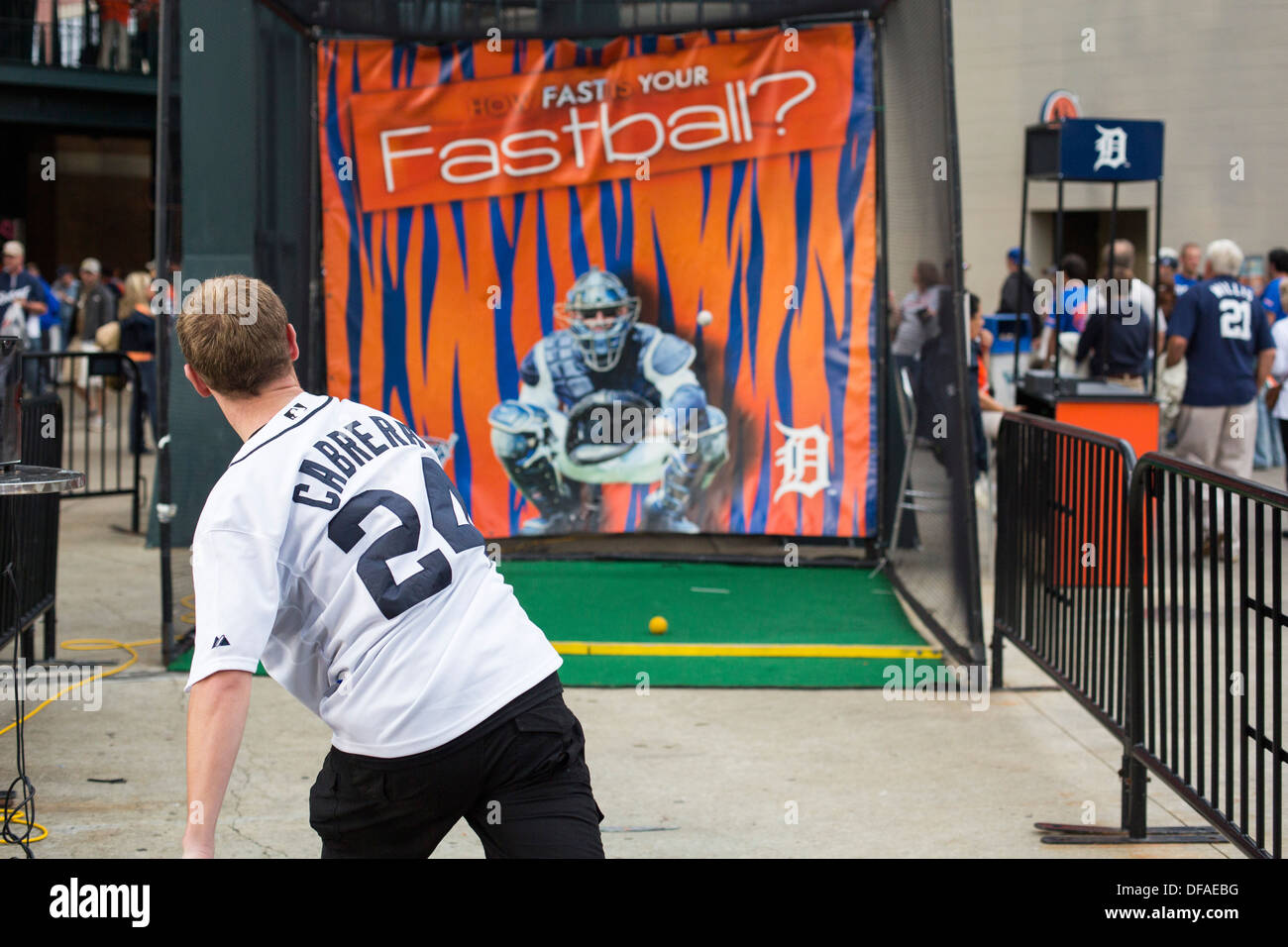 A Detroit Tigers fan tests his pitching arm before a game at Comerica Park Stock Photo