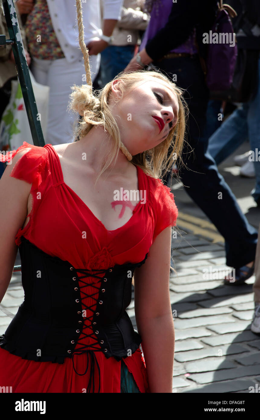 Theatre group promoting their show (woman being hung) during the Festival Fringe in the Royal Mile, Edinburgh, Scotland. Stock Photo