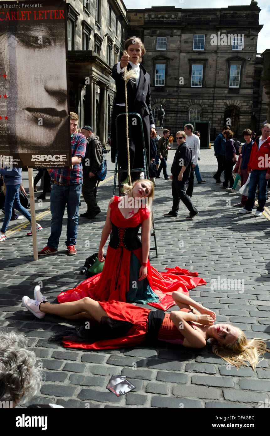 Theatre group promoting their show (woman being hung) during the Festival Fringe in the Royal Mile, Edinburgh, Scotland. Stock Photo