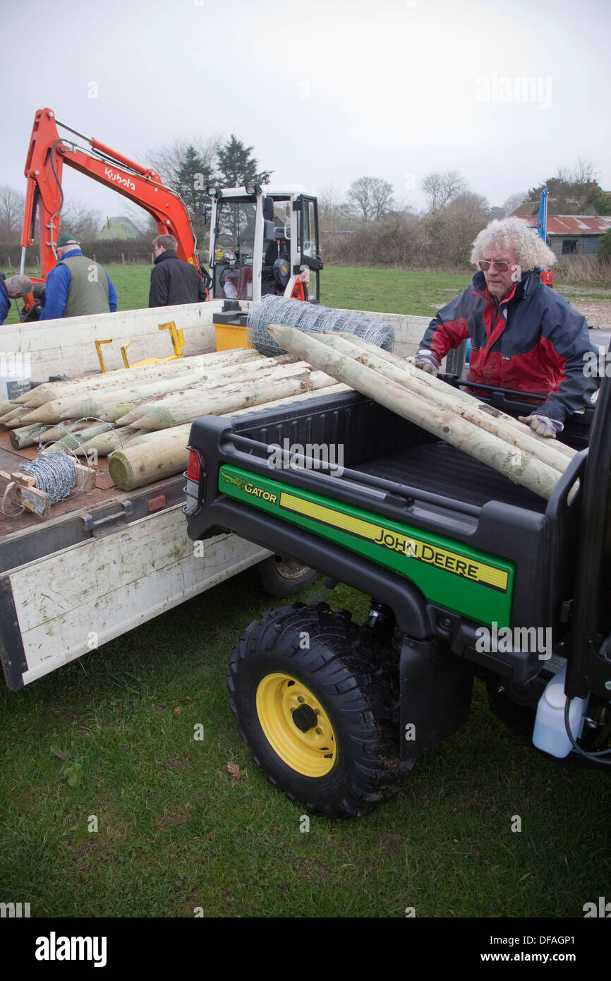 Loading fence posts on to a John Deere Gator UK Stock Photo - Alamy