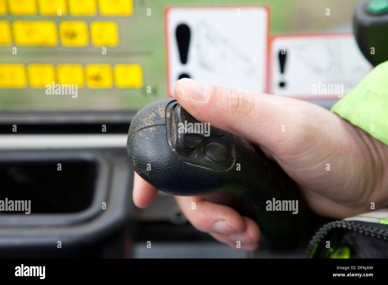 A man controls the joystick of a Kubota mini digger UK Stock Photo - Alamy
