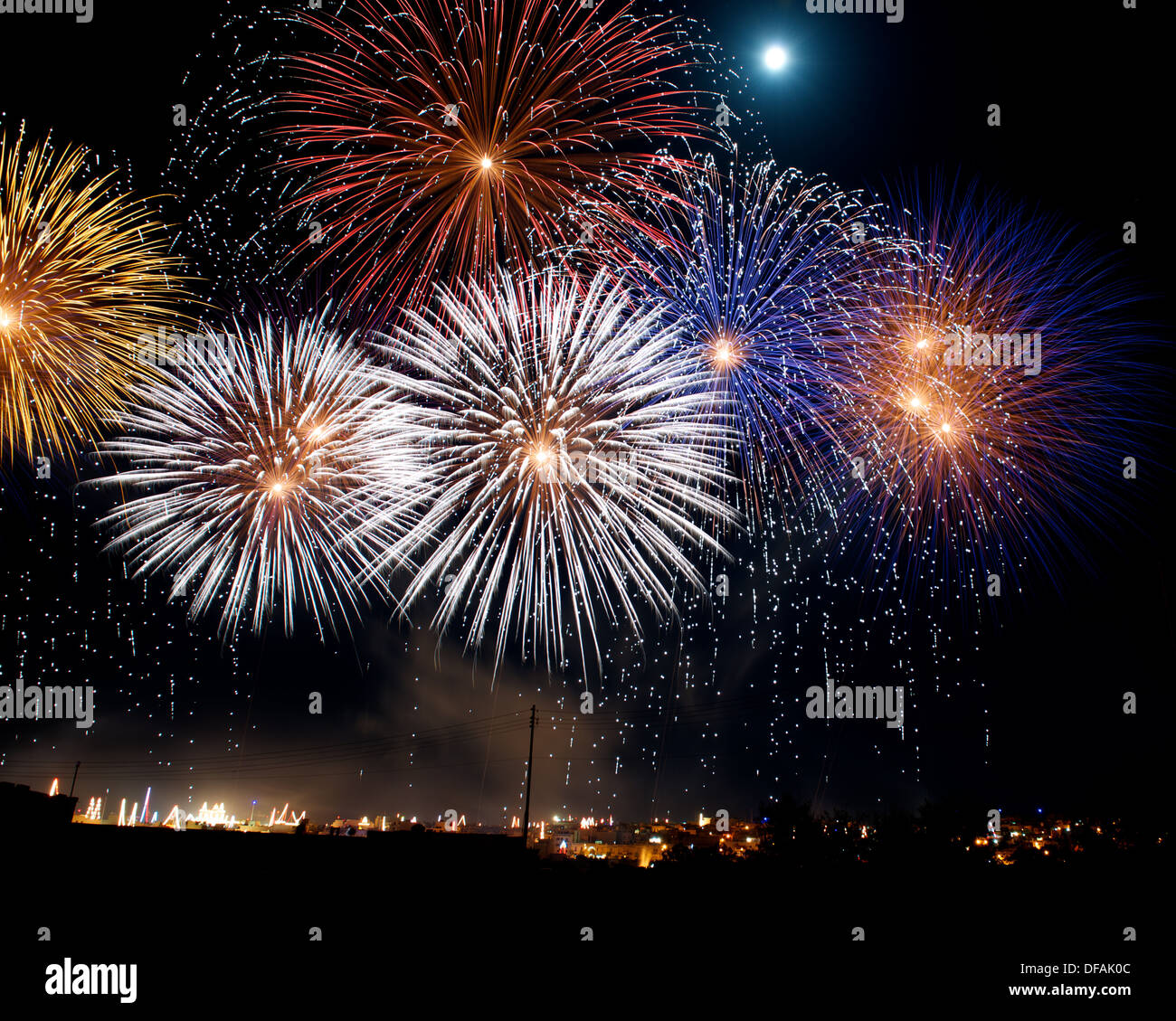 Colorful fireworks with the moon in the Malta, dark sky background and