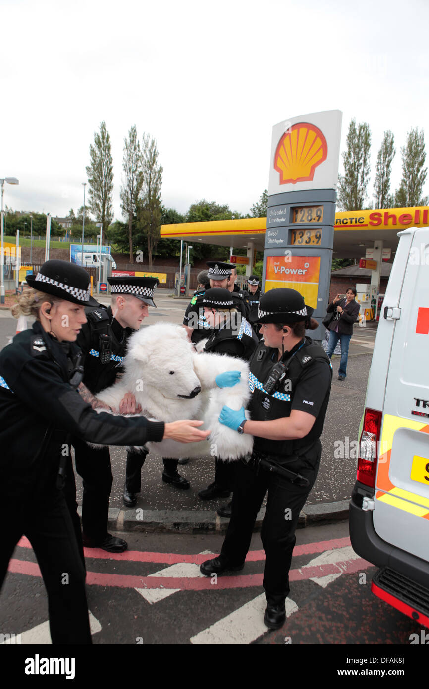 A Greenpeace campaigner dressed as a polar bear is arrested during his attempt to shut down Shell petrol station in Edinburgh Stock Photo