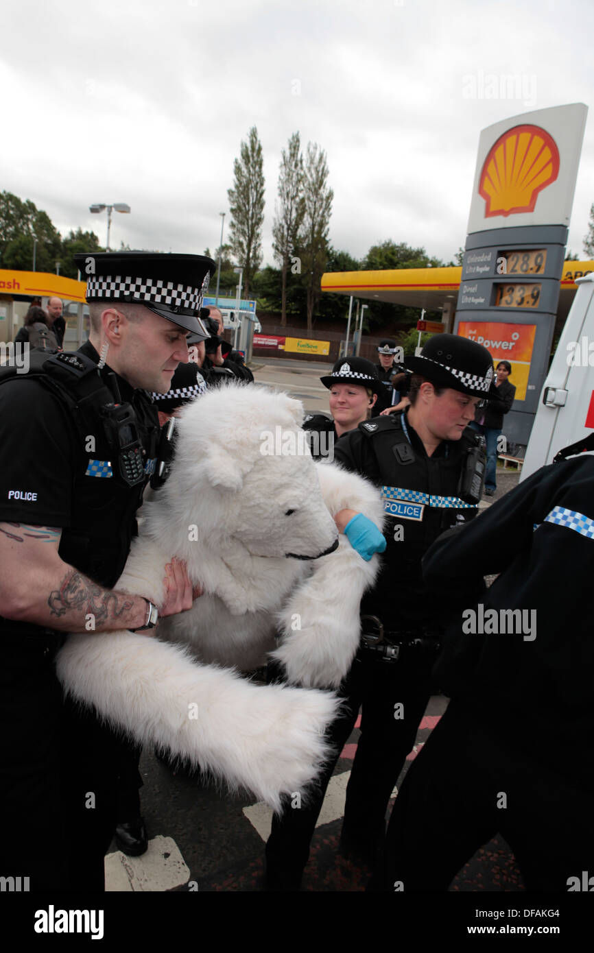 A Greenpeace campaigner dressed as a polar bear is arrested during his attempt to shut down Shell petrol station in Edinburgh Stock Photo