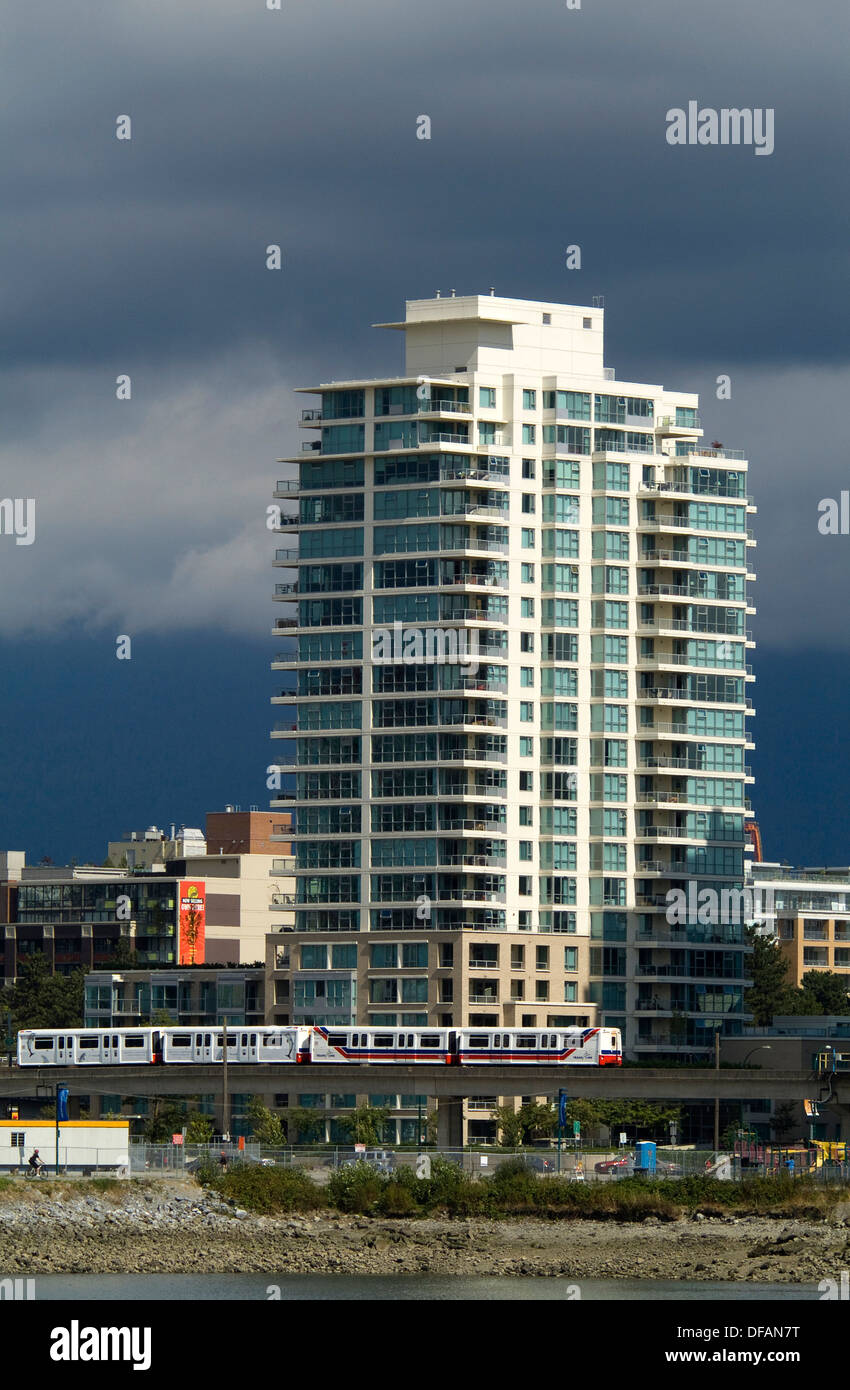 The Skytrain passes below an apartment tower at the east end of False