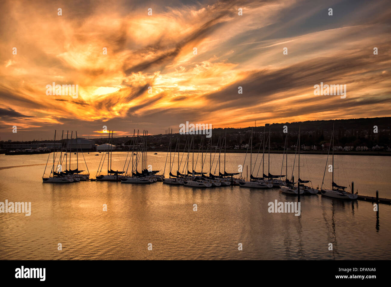 boats moored with the sun setting Stock Photo - Alamy