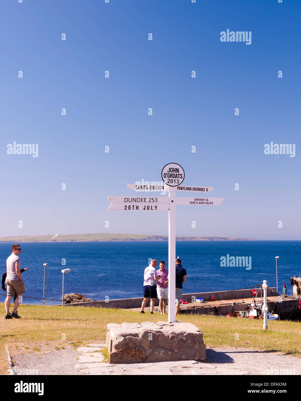 John o groats sign with people around and islands in background Stock Photo