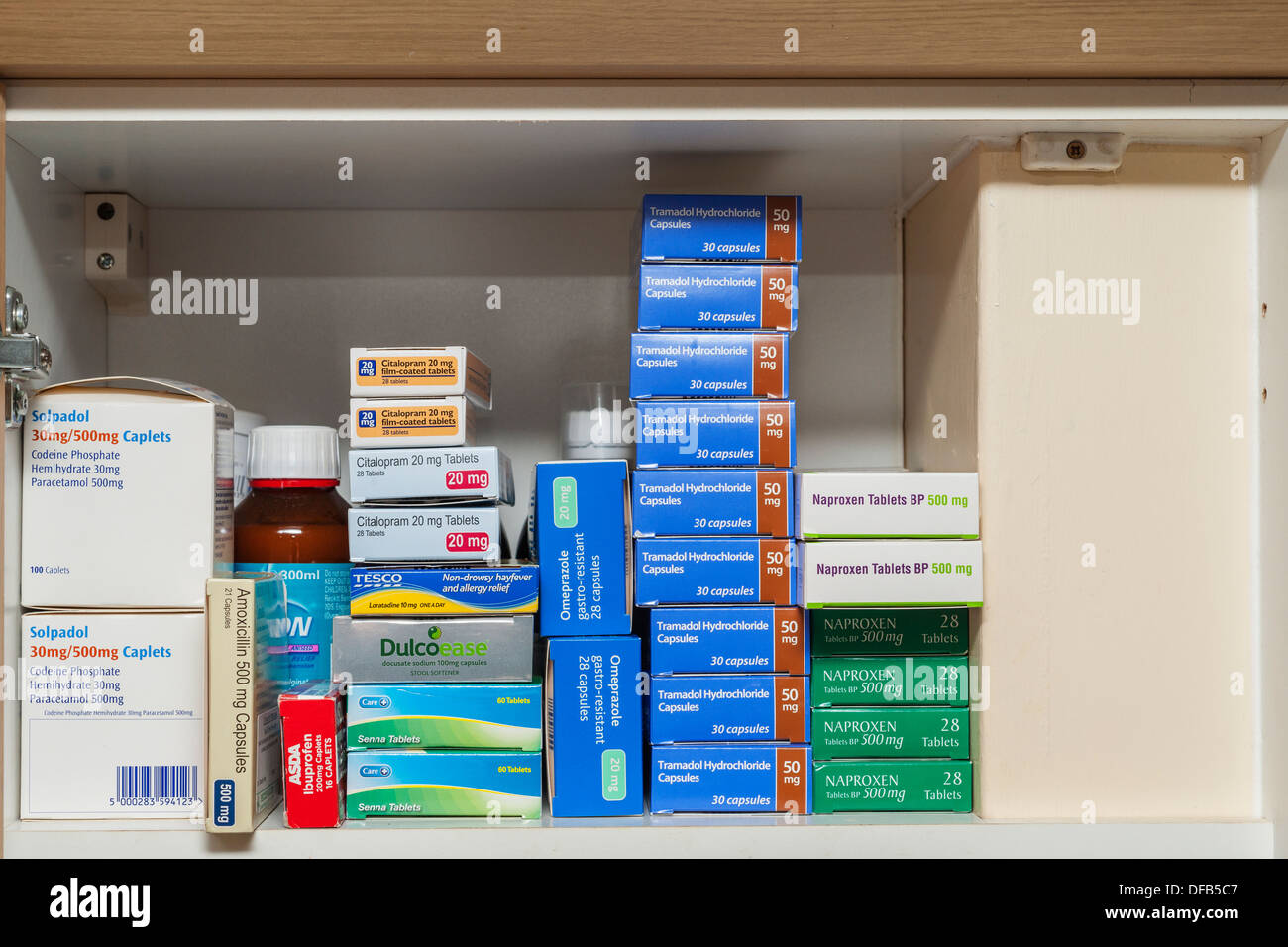 A cupboard full of prescription pills and medication due to patient suffering with back pain Stock Photo