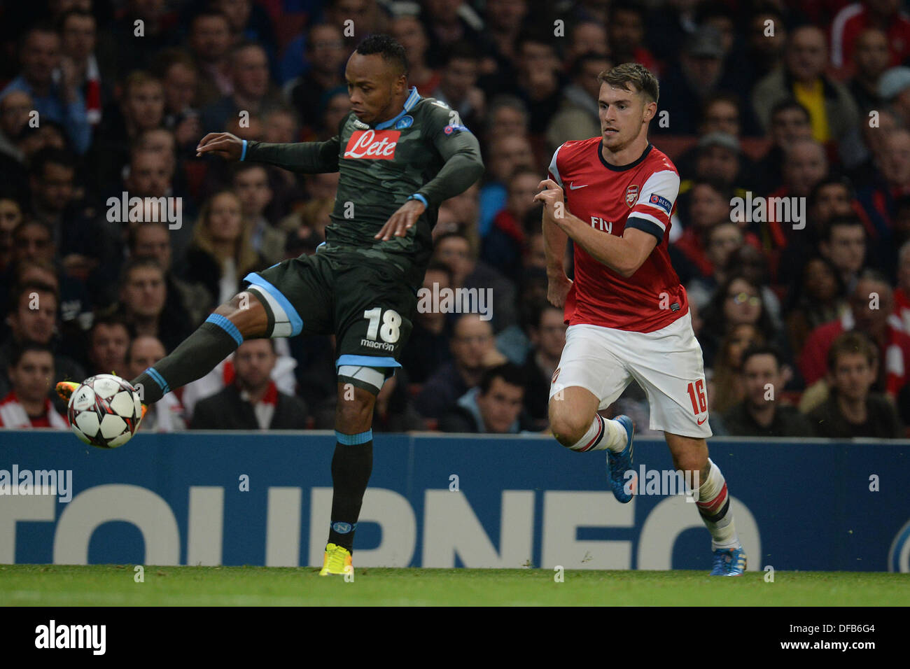 London, UK. 01st Oct, 2013. Napoli's defender Camilo Zuniga from Columbia and Arsenal's midfielder Aaron Ramsey from Wales during the UEFA Champions League match between Arsenal from England and Napoli from Italy played at The Emirates Stadium, on October 01, 2013 in London, England. © Mitchell Gunn/ESPA/Alamy Live News Stock Photo