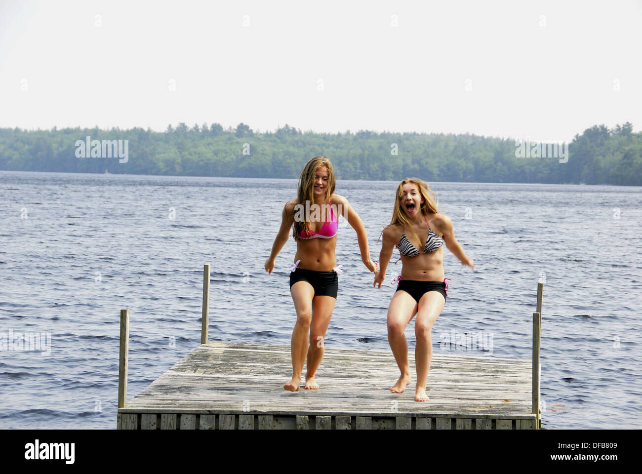 girl 13 girl 18 yrs about to jump into lake from dock Stock Photo ...