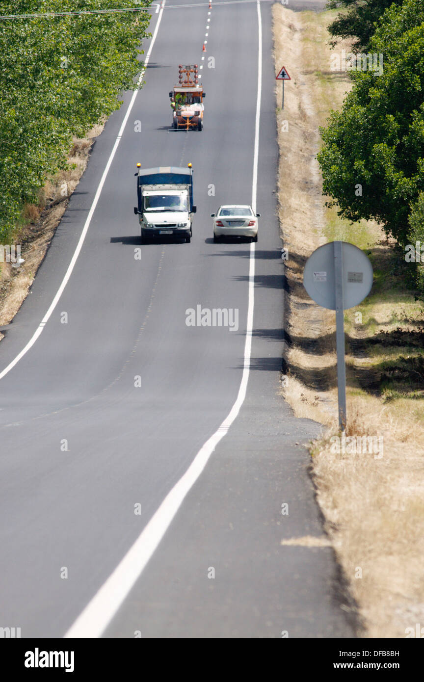 Road marking painting, LU-633 road in Paradela, Sarria, Province of Lugo, Galicia, Northern Spain Stock Photo