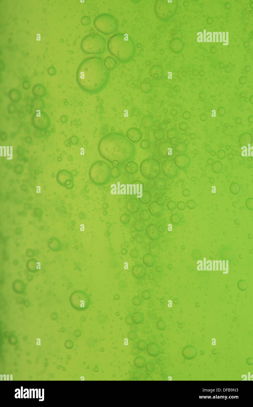 Green abstract blurred liquid background with soap bubbles Stock Photo ...
