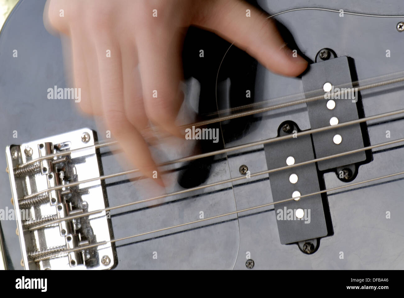 Hand playing bass guitar Stock Photo