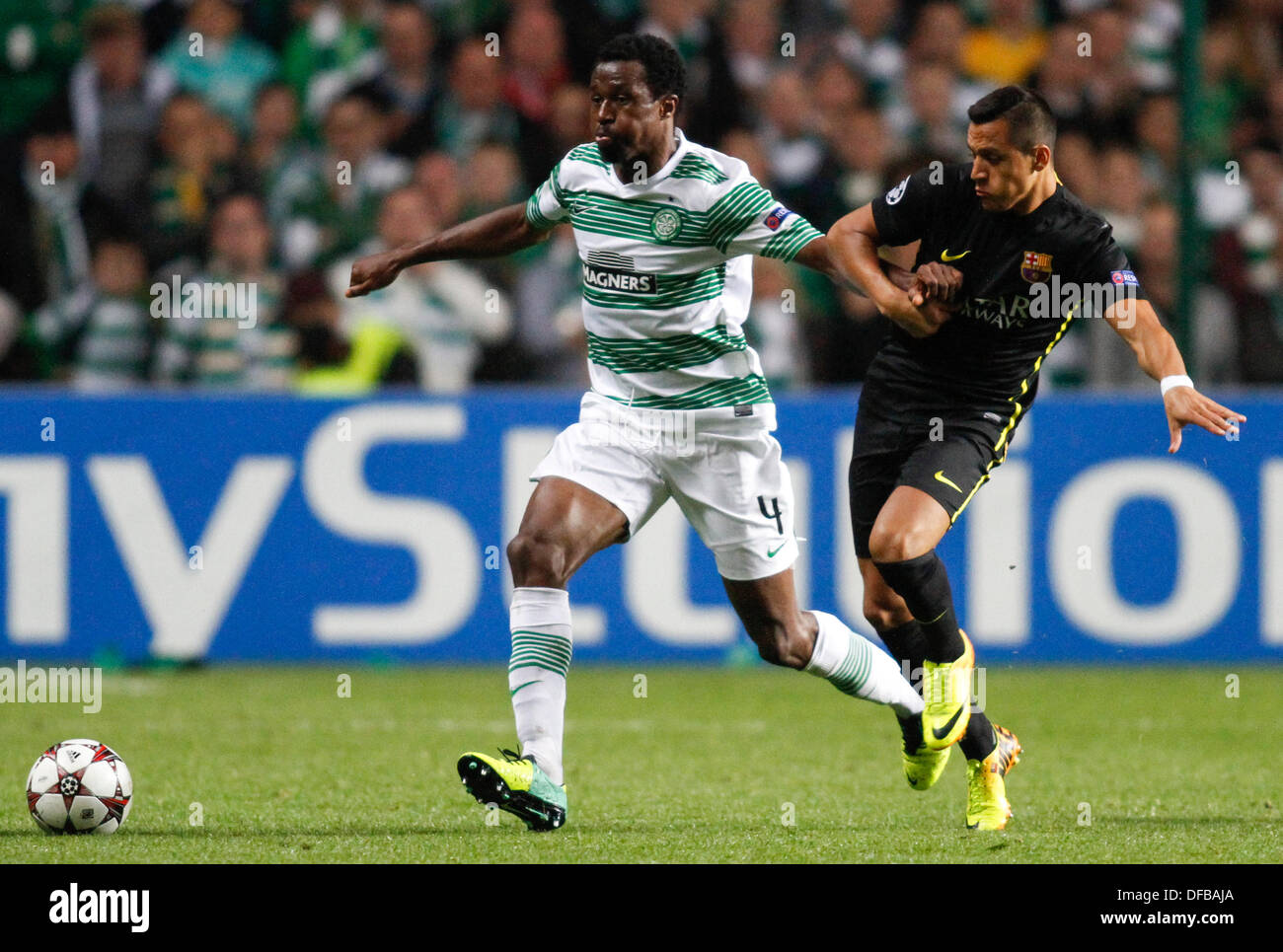 Glasgow, Scotland. 01st Oct, 2013. Efe Ambrose holds off Sergio Busquets during the Champions League game between Celtic and Barcelona from Celtic Park. © Action Plus Sports/Alamy Live News Stock Photo