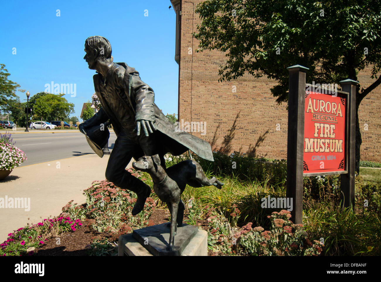 Statue of a firefighter and fire safety dog at the Aurora Regional Fire Museum in Aurora, Illinois Stock Photo