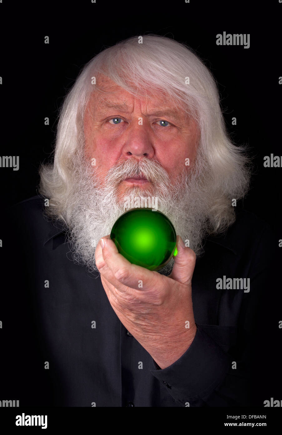 Magic Ball - man with green crystal ball Stock Photo