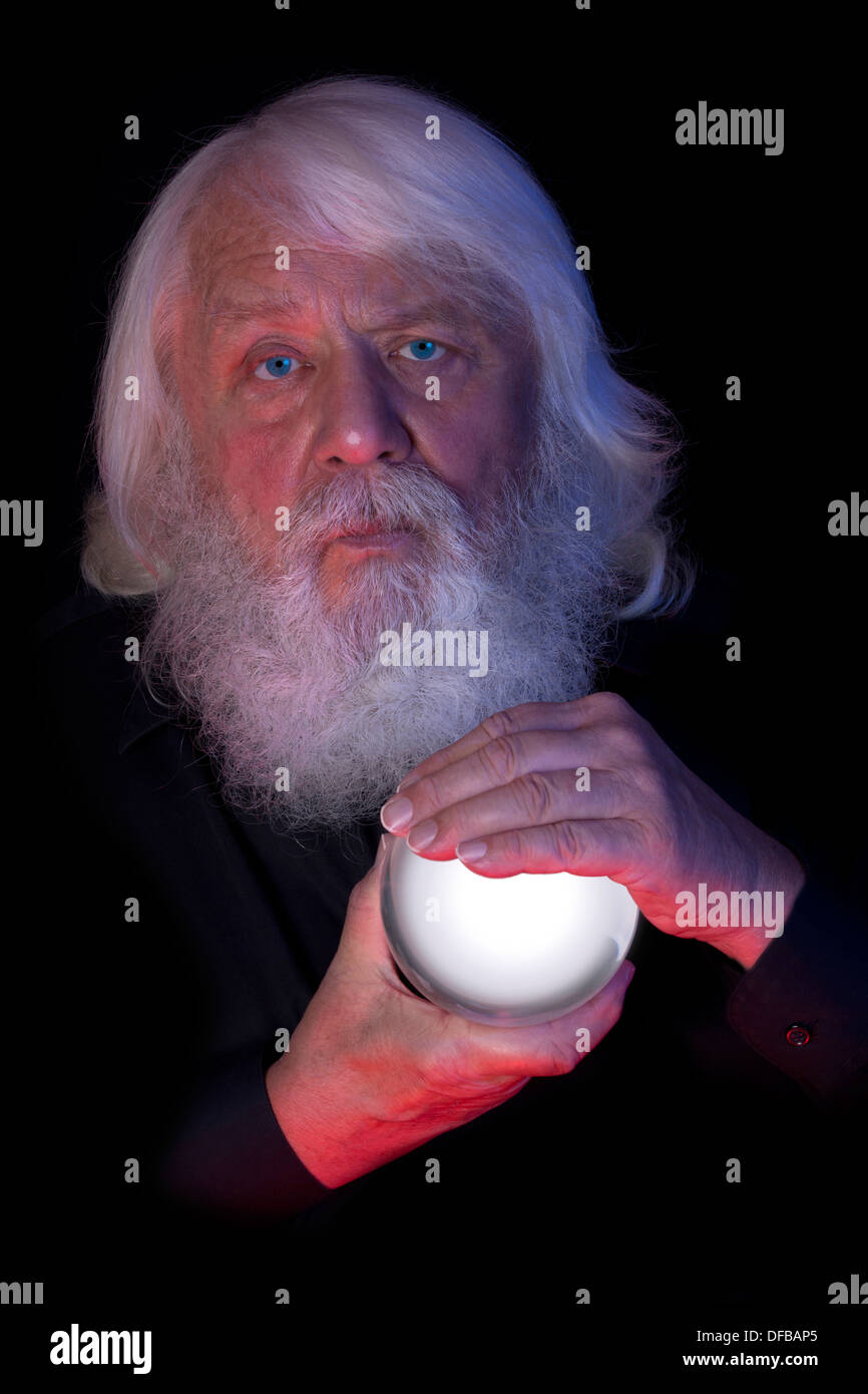 Magic Ball - Magician with white crystal ball Stock Photo