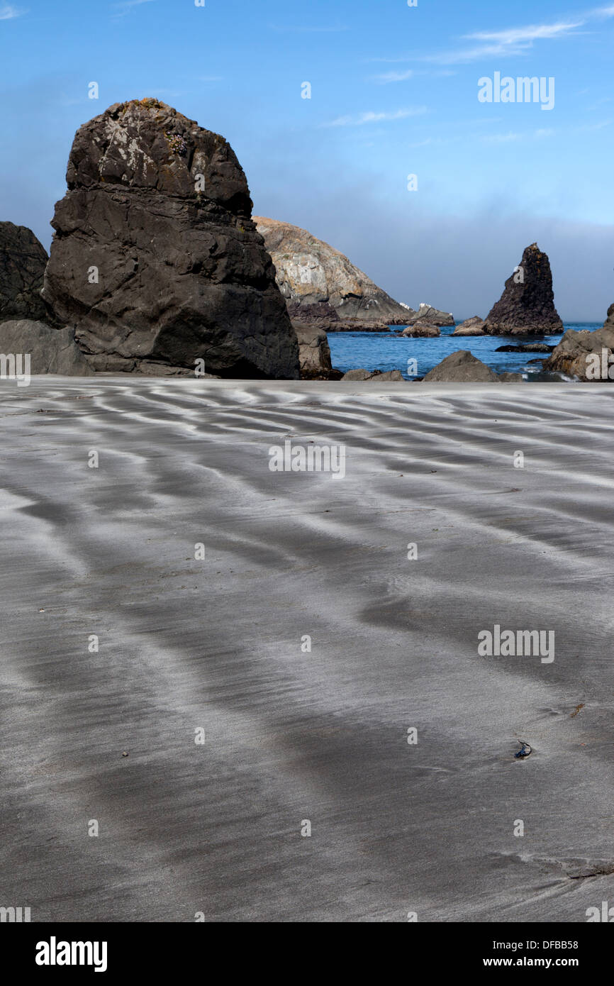 Striations in the sand at Rainbow Rock Beach near Brookings Oregon are exposed at low tide. Stock Photo