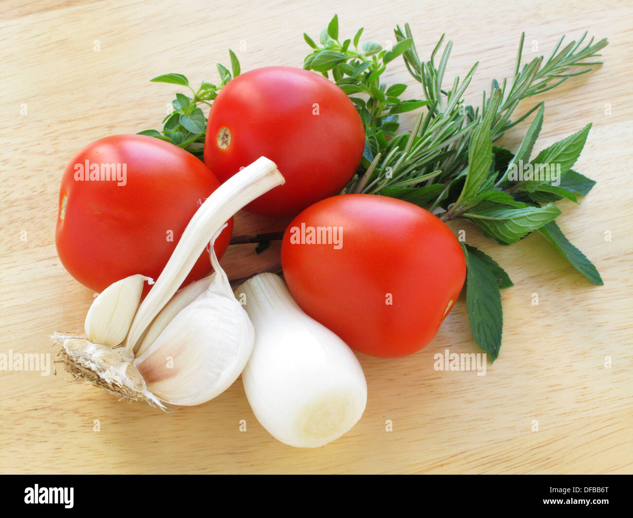 Onion, tomato and garlic with aromatic herbs Stock Photo Alamy