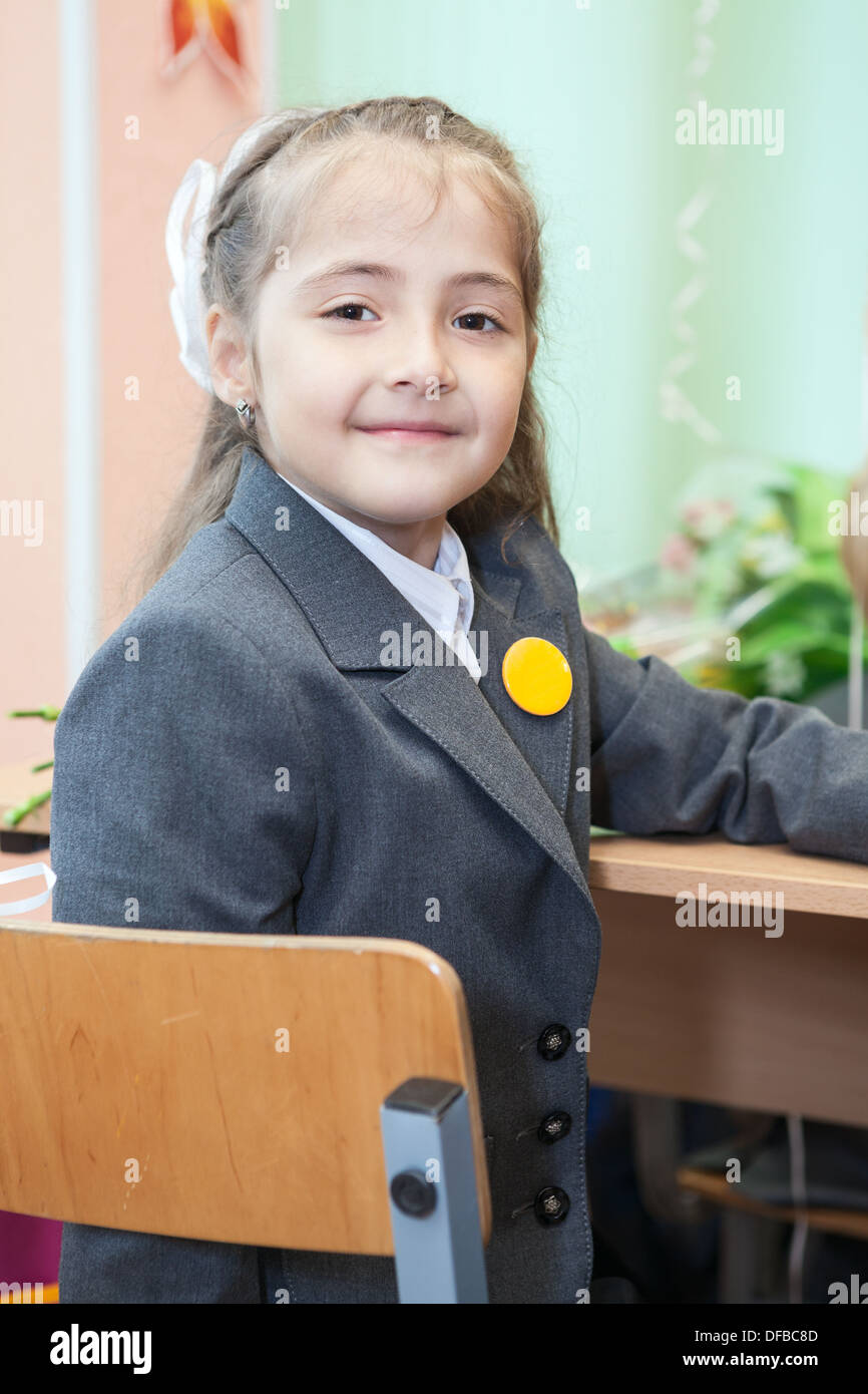 Seven Ears Old Smiling Girl Sitting In Russian Classroom At The
