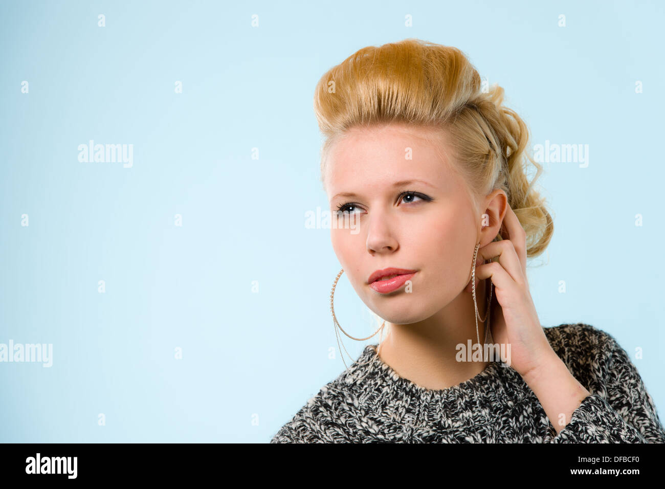 Portrait of young beautiful girl, blue background, horizon format Stock Photo