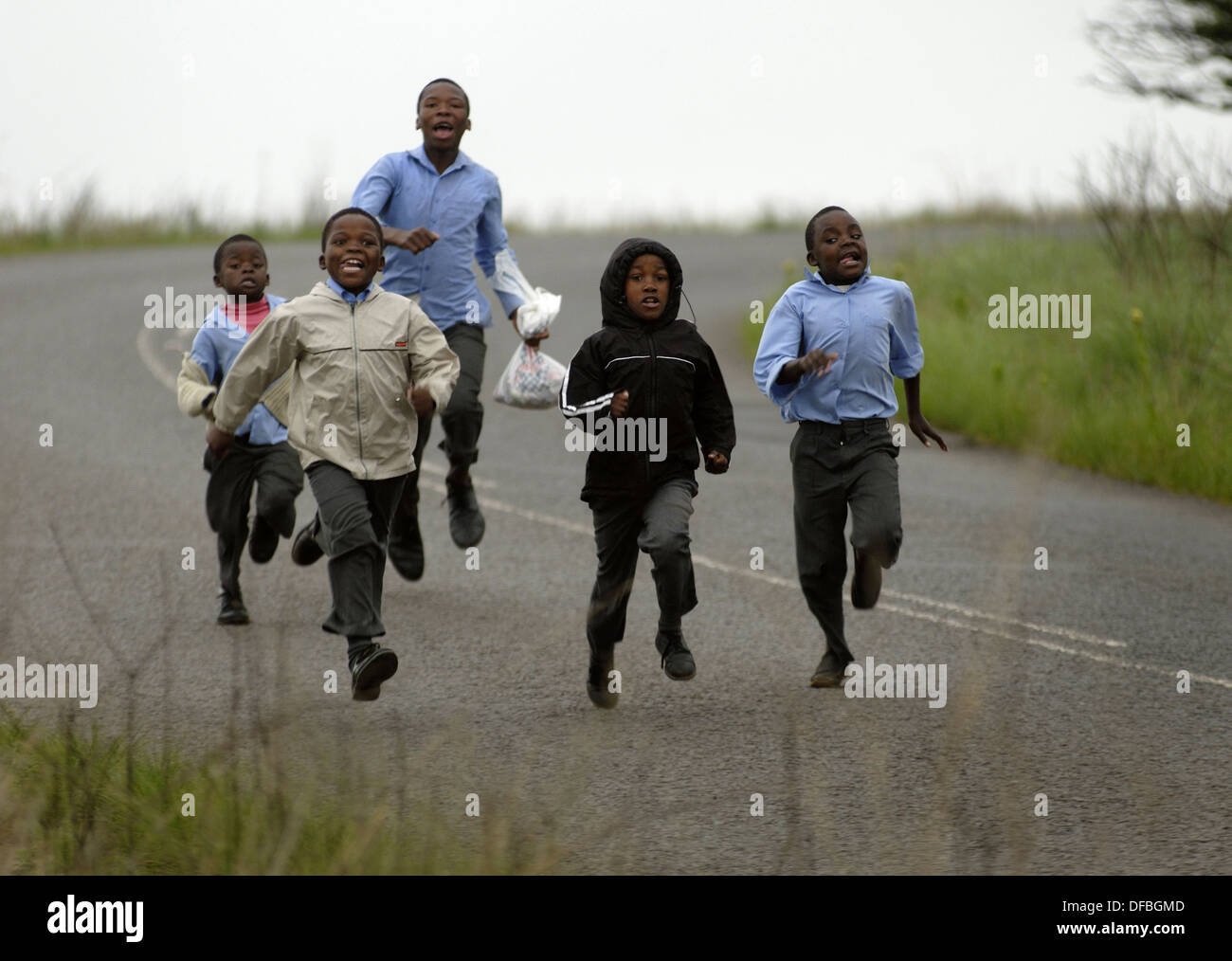 Children run to school to school in Umlaas Road, 18 October 2007. Stock Photo