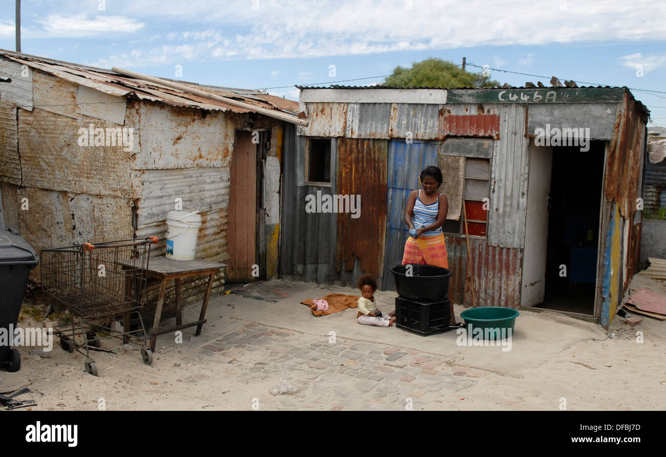 A woman washes clothes her home in Site C Khayelitsha near Cape Town as