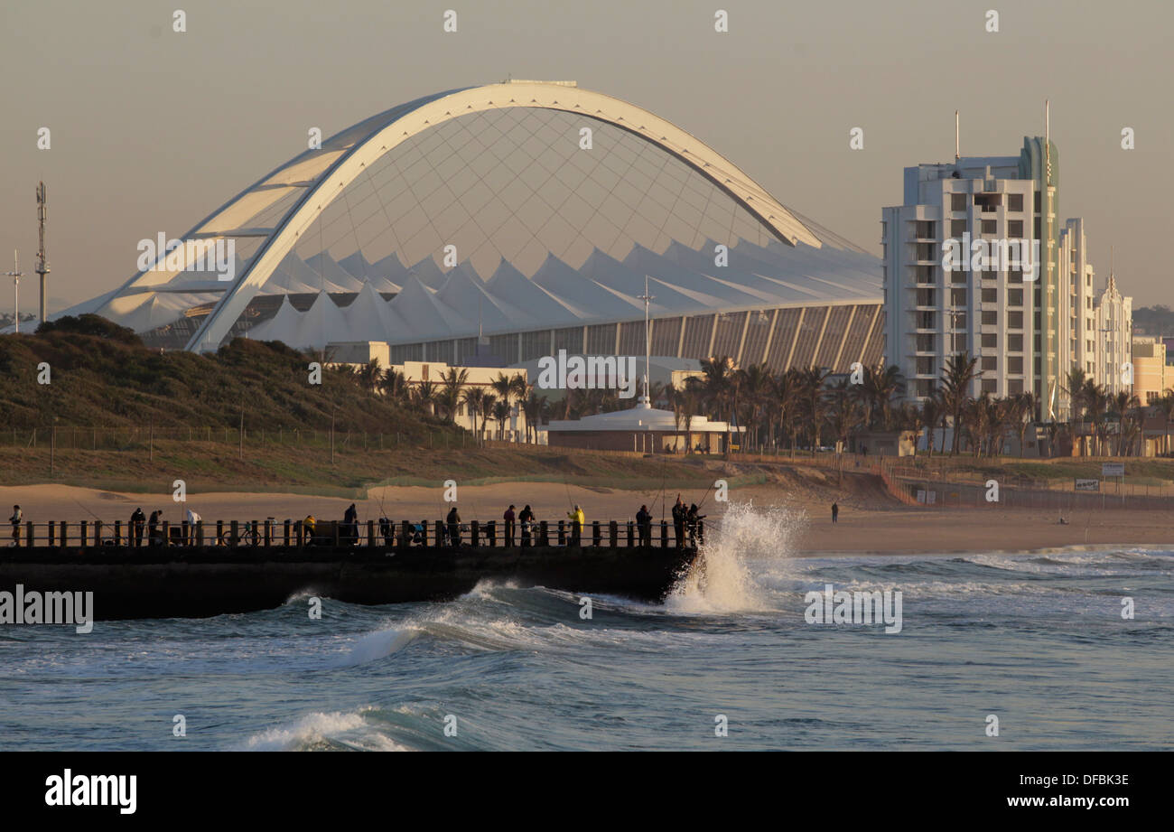 the-moses-mabhida-stadium-is-visible-behind-fishermen-casting-a-line