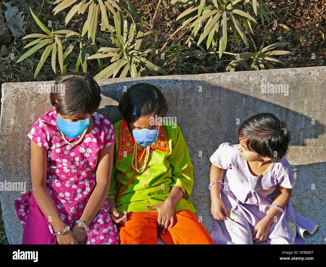 Small Girls in a garden with Precaution masks for Swine Flu, H1N1 Stock Photo