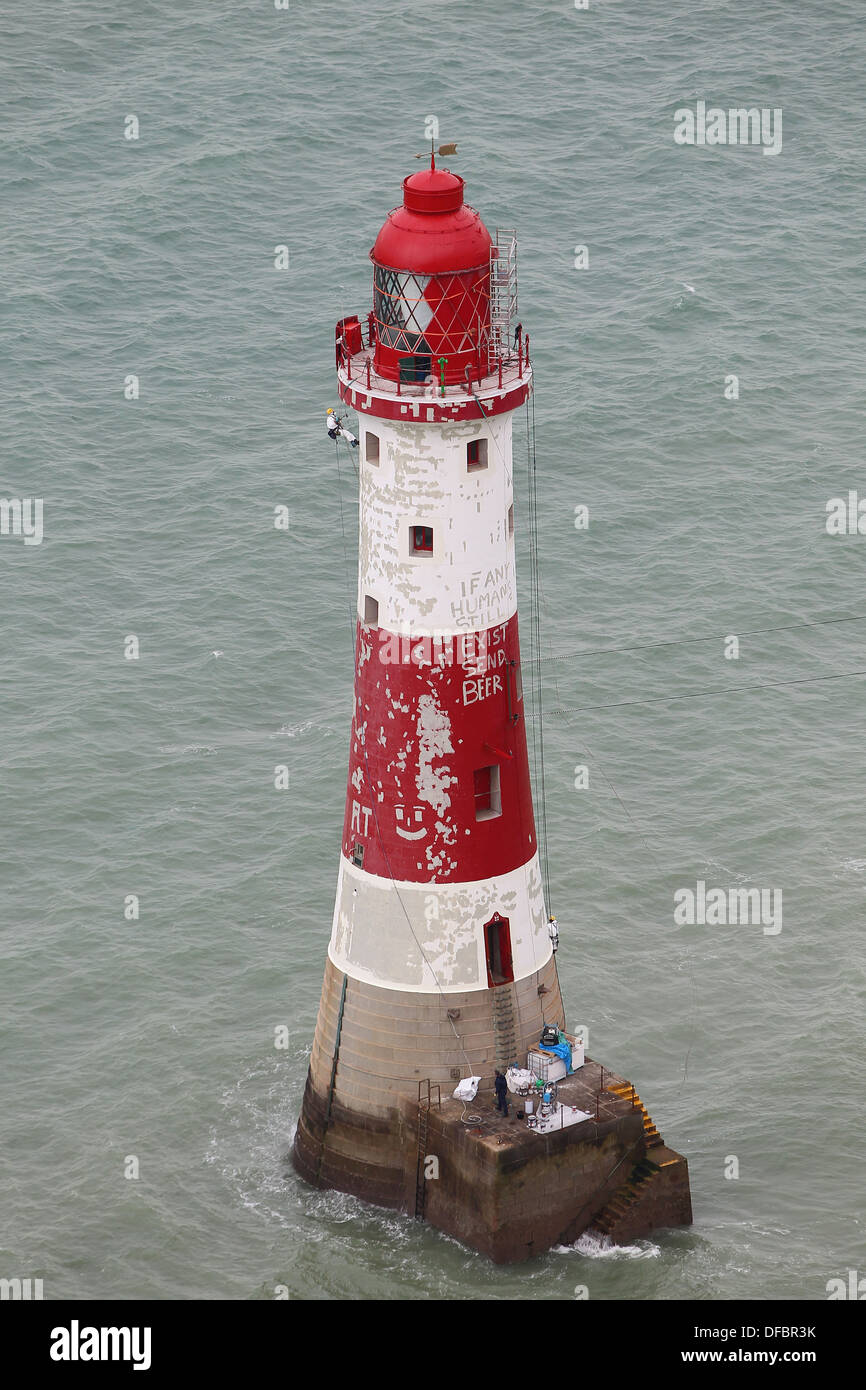 A painter works on repainting the stripes around the lighthouse at Beachy Head. Picture by James Boardman. Stock Photo